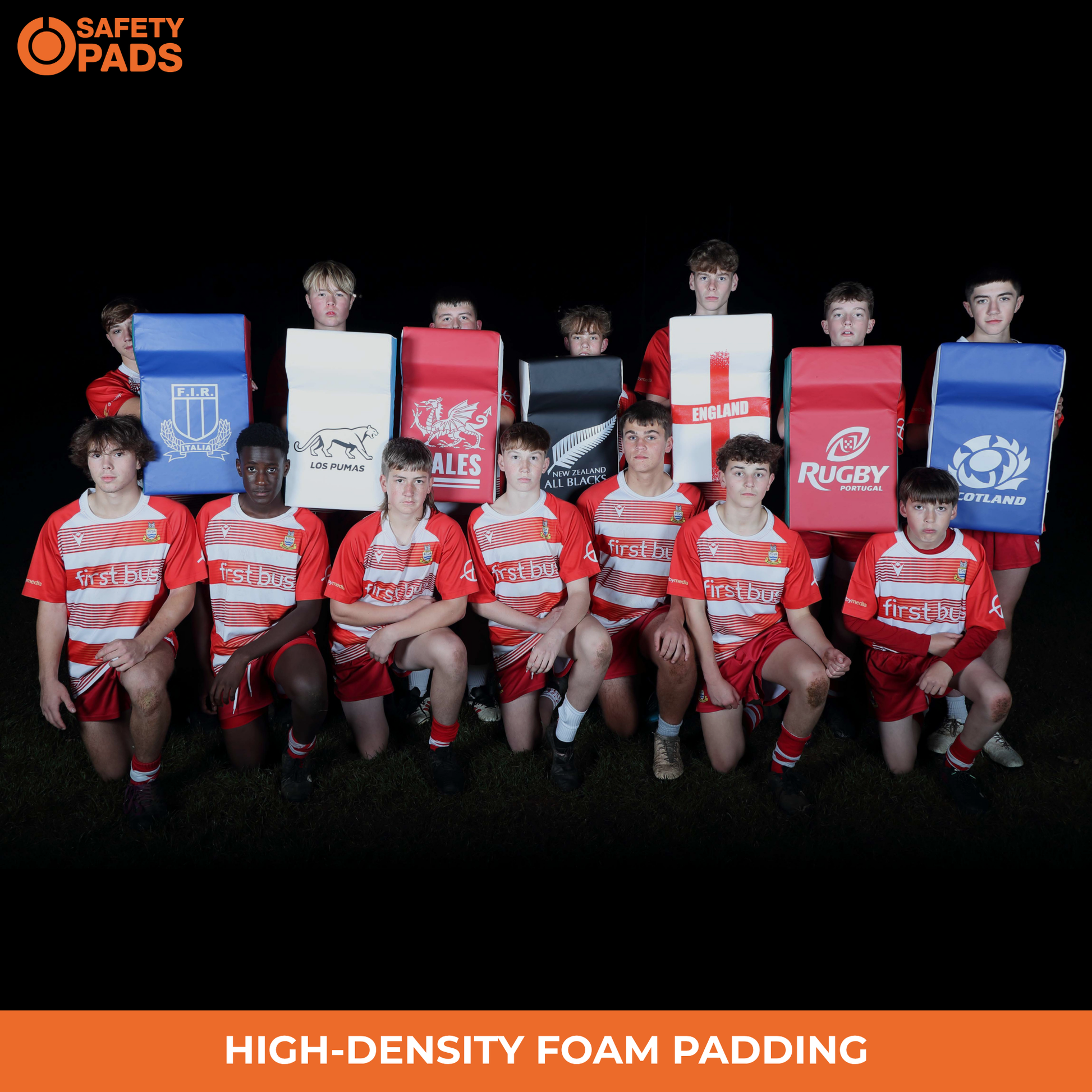 A group of young rugby players wearing red and white striped jerseys pose with large foam training pads branded with rugby unions and Safety Pads. The image has a black background with an orange banner at the bottom reading 'HIGH-DENSITY FOAM PADDING' and a Safety Pads logo in the top left.