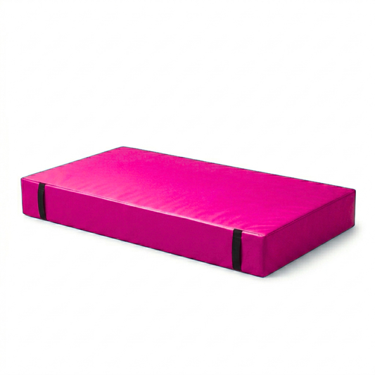 A bright pink rectangular foam exercise pad with black elastic side straps, shown on a plain white background.