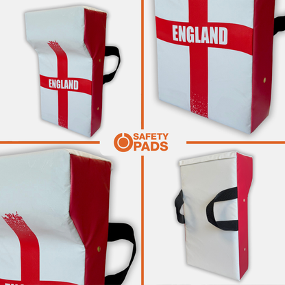 Four views of a rectangular England flag safety pad by Safety Pads, featuring a white background with a red St. George's cross, black carrying handles, and the word 'ENGLAND' printed in white.