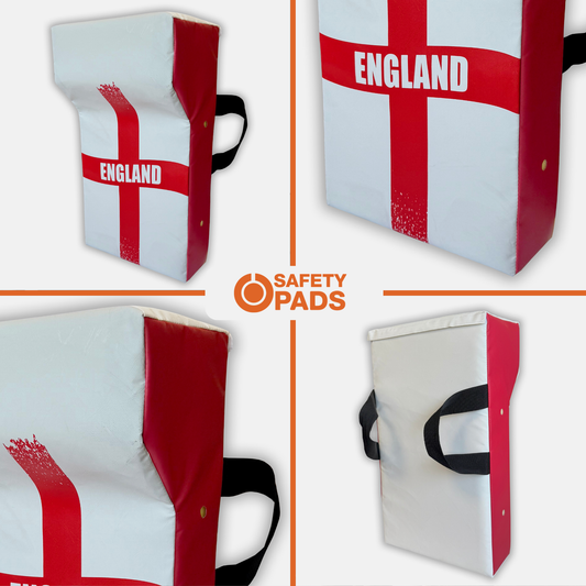 Four views of a rectangular England flag safety pad by Safety Pads, featuring a white background with a red St. George's cross, black carrying handles, and the word 'ENGLAND' printed in white.