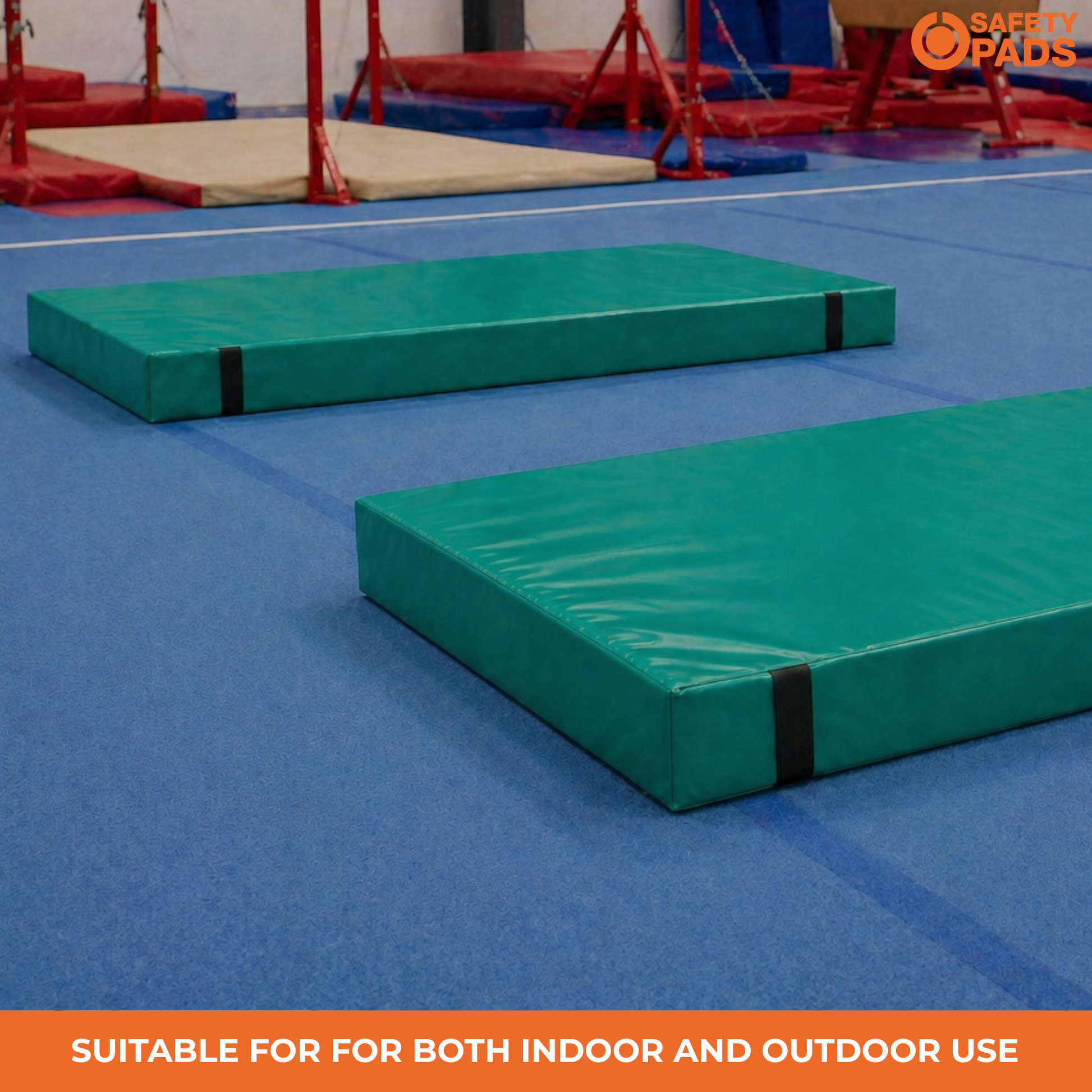 Two green outdoor gymnastics mats on a blue gym floor, with a red balance beam apparatus in the background. An orange banner at the bottom reads 'SUITABLE FOR BOTH INDOOR AND OUTDOOR USE', and a 'Safe Spads' logo is in the top right corner.